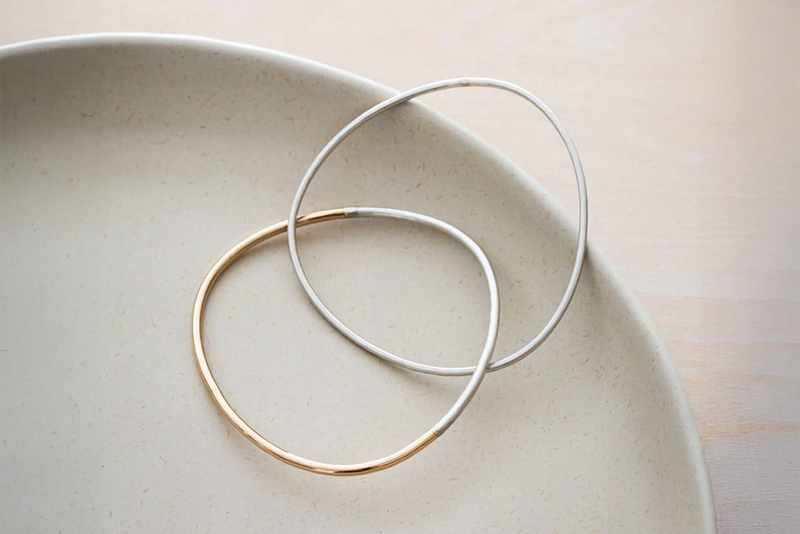 B101.2s.yg 2-Loop Two-Toned and Monotone Interlocking Bangle in Silver and Yellow Gold